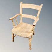 An antique pine farmhouse armchair