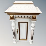 A 20th century painted wall cabinet with pillar supports