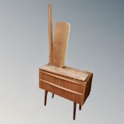 A Danish mid century two drawer chest on raised legs together with a teak wall shelf