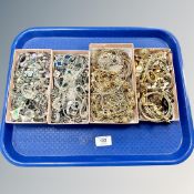 A tray of silver tone and gold tone costume jewellery