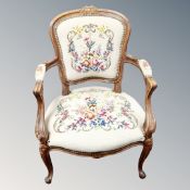 A carved beech framed salon armchair in tapestry fabric