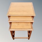 A nest of three teak G-Plan tables