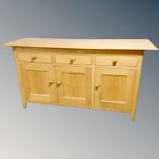 A contemporary oak three door sideboard