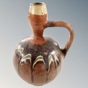 An antique glazed pottery wine jug, height 28cm.