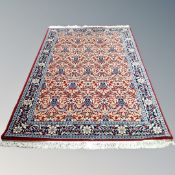A machine made Keshan design rug on red ground 150 cm x 230 cm