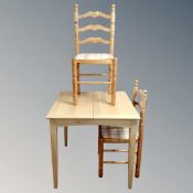 A contemporary square extending table fitted a leaf together with a pair of pine ladder backed