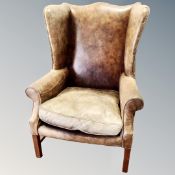 A pair of vintage studded leather high backed fire side chairs