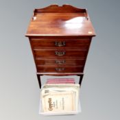 An Edwardian mahogany four drawer music chest on raised legs together with a small quantity of