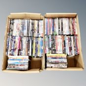 Two boxes containing approximately 100 dvds
