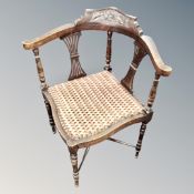 An early 20th century carved beech corner chair
