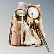 A box containing an Edwardian oak cased mantel clock, brass and leather magazine rack, desk stand,