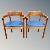 A pair of 20th century Danish Munch Mobler teak elbow chairs