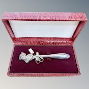 A silver plated child's rattle