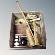 An antique wooden drawer containing brass candlestick, vintage magnifying set in mahogany case,