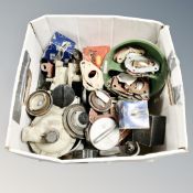 A box of vintage car parts including petrol caps