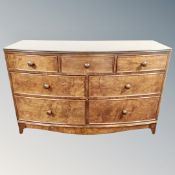A Victorian style bow fronted seven drawer chest