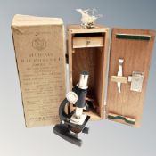 A student microscope model III in fitted wooden case with original box