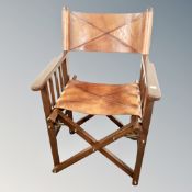 A contemporary leather upholstered folding campaign-style chair