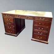 A 19th century twin pedestal desk fitted with eleven drawers with leather inset panel