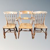 A pair of elm and beech spindle backed chairs together with armchair,