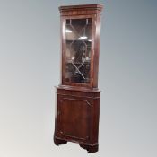 An astragal glazed corner cabinet with cupboard below