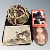 An army helmet, Royal Scots Fusilier's plaque on board, metal panel depicting a battle ship,