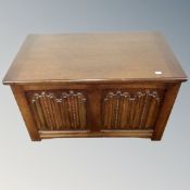 An oak linen fold blanket box, 76cm wide by 43cm deep by 45cm high.