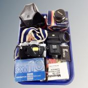 An Olympus OM camera with lens, Miranda lens and flash,