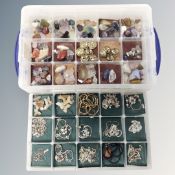 A plastic lidded box with two compartmental sections containing jewellery, crystals,