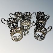 A set of eight ornate Victorian silver cup holders decorated with putti