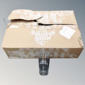 A box of 24 John Smiths branded pint glasses