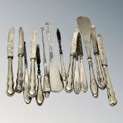 A collection of silver handled cutlery, button hooks,