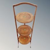 An Edwardian three tier folding cake stand