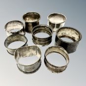 Eight assorted silver serviette rings.