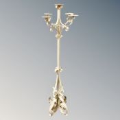A wrought metal floor standing five-way candleabrum