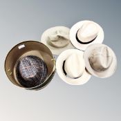 A contemporary hat box containing six hats, deer stalker,