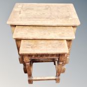 A nest of three oak tables