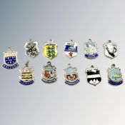 Eleven silver charm crests