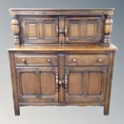 An Ercol court cupboard in antique finish