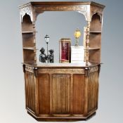 A carved oak linen fold cocktail bar