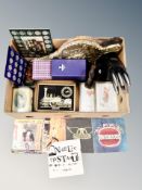 A box containing bronzed figure of Lester Piggot on horseback, shell coin sets, seven inch singles,
