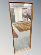 A 1970's teak framed mirror,
