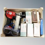 A crate containing a Clarke air nail gun together with a further nail gun,