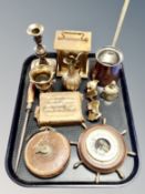 A tray of antique and later brass ornaments and candlesticks, ships wheel barometer,