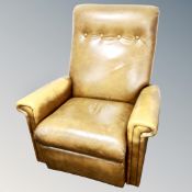 A mid century tan buttoned leather reclining armchair