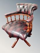 A Chesterfield oxvlood leather captain's desk chair CONDITION REPORT: Several