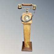 A retro style telephone on leather pedestal