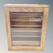 A Millbrook Furnishing wall mounted military display cabinet fitted a drawer and shelves,