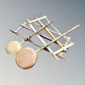 Two antique beech handled bed warming pans together with two vintage frame saws