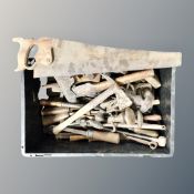 A plastic crate containing vintage hand tools